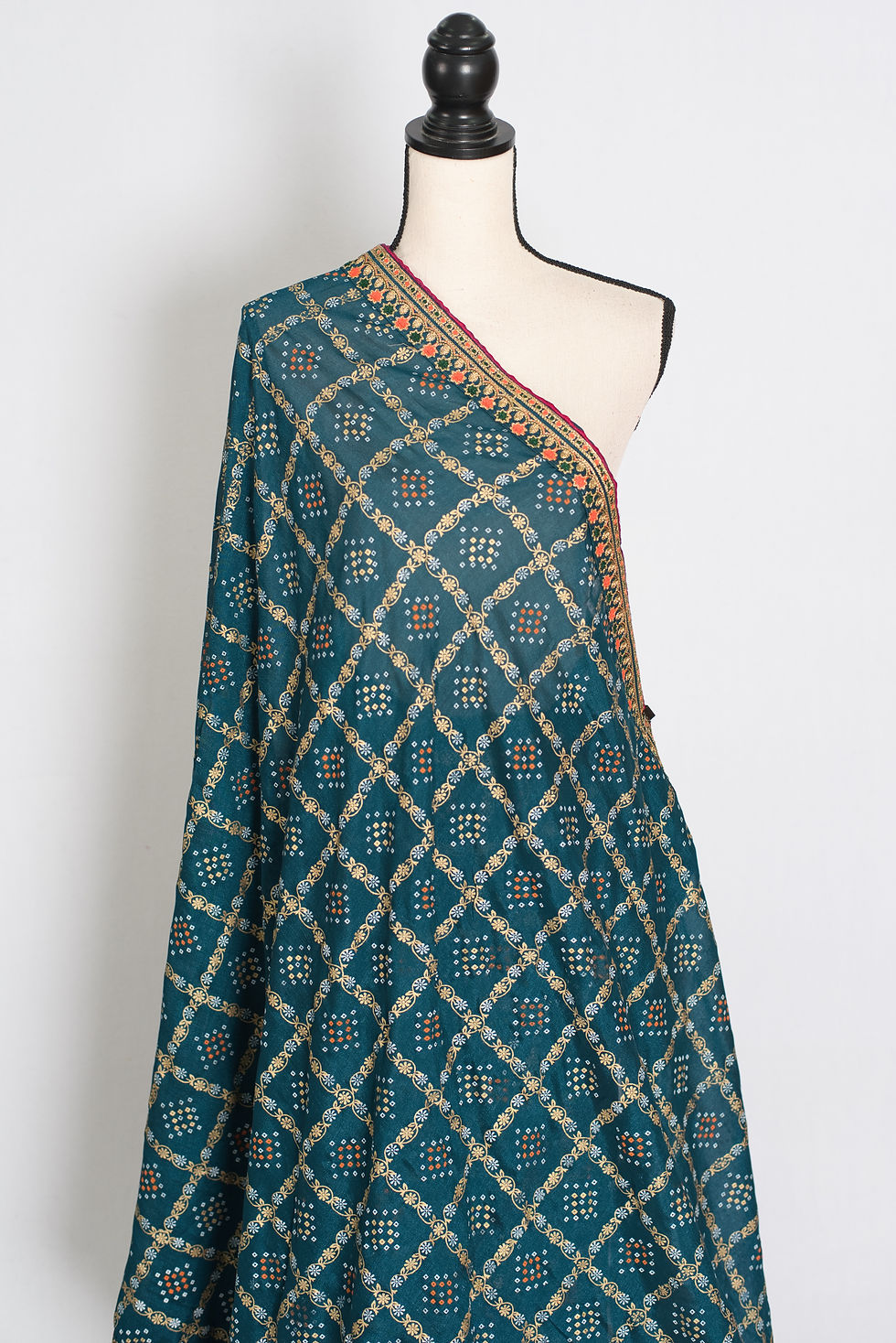 Thumbnail: Greenish blue Gharchola saree on a mannequin showing the gold zari grid and traditional Bandhani print.