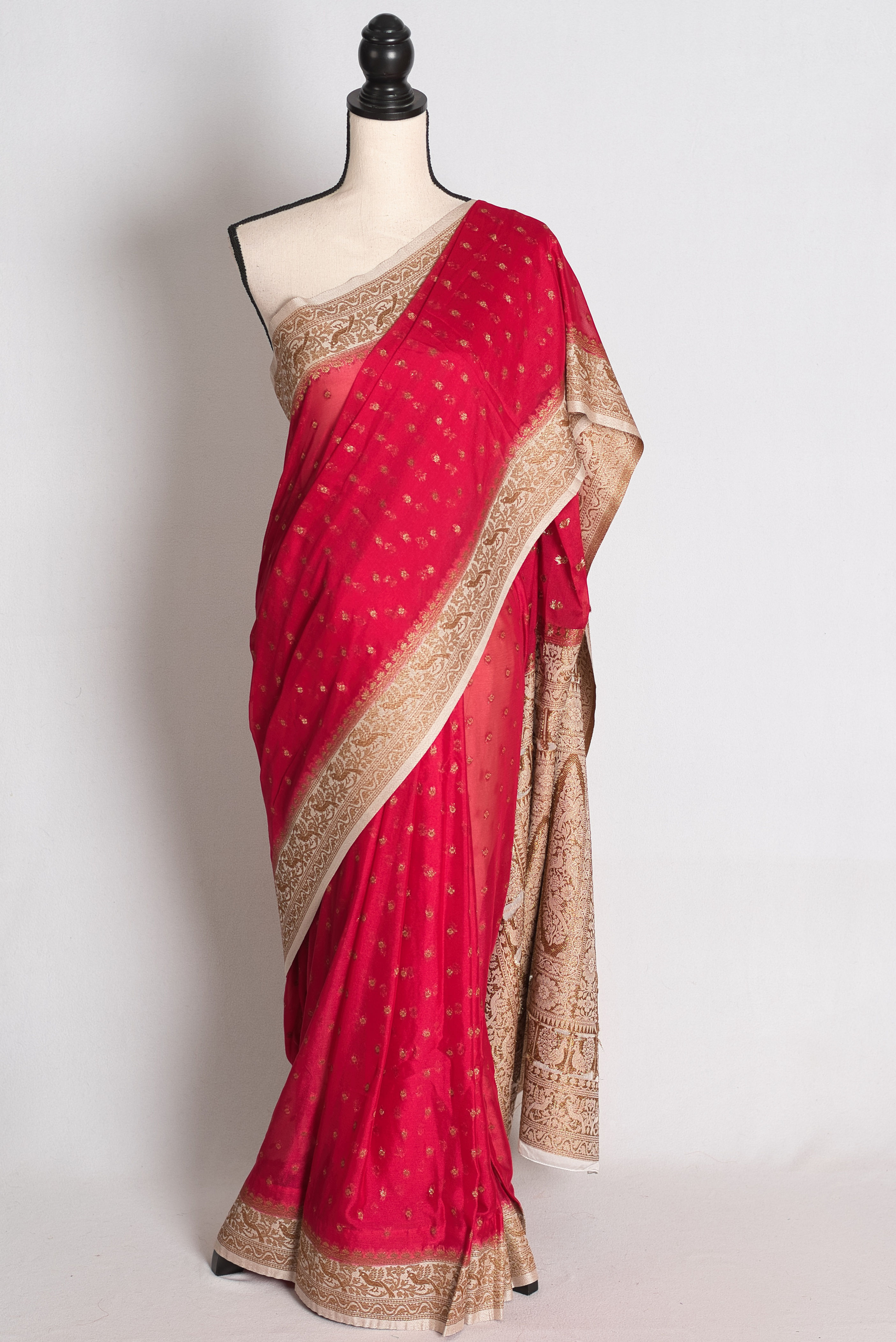 Dark Pink Semi Georgette Banarasi Saree draped elegantly on a mannequin showcasing its contrasting off-white border and pallu
