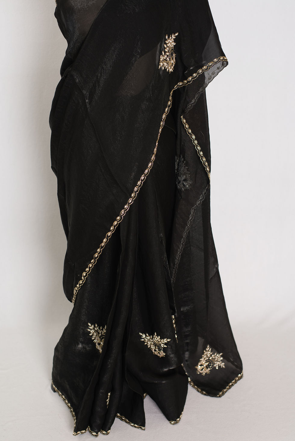 Thumbnail: Kajal black and gold glass tissue saree with heavy hand-embroidered cut dana work.
