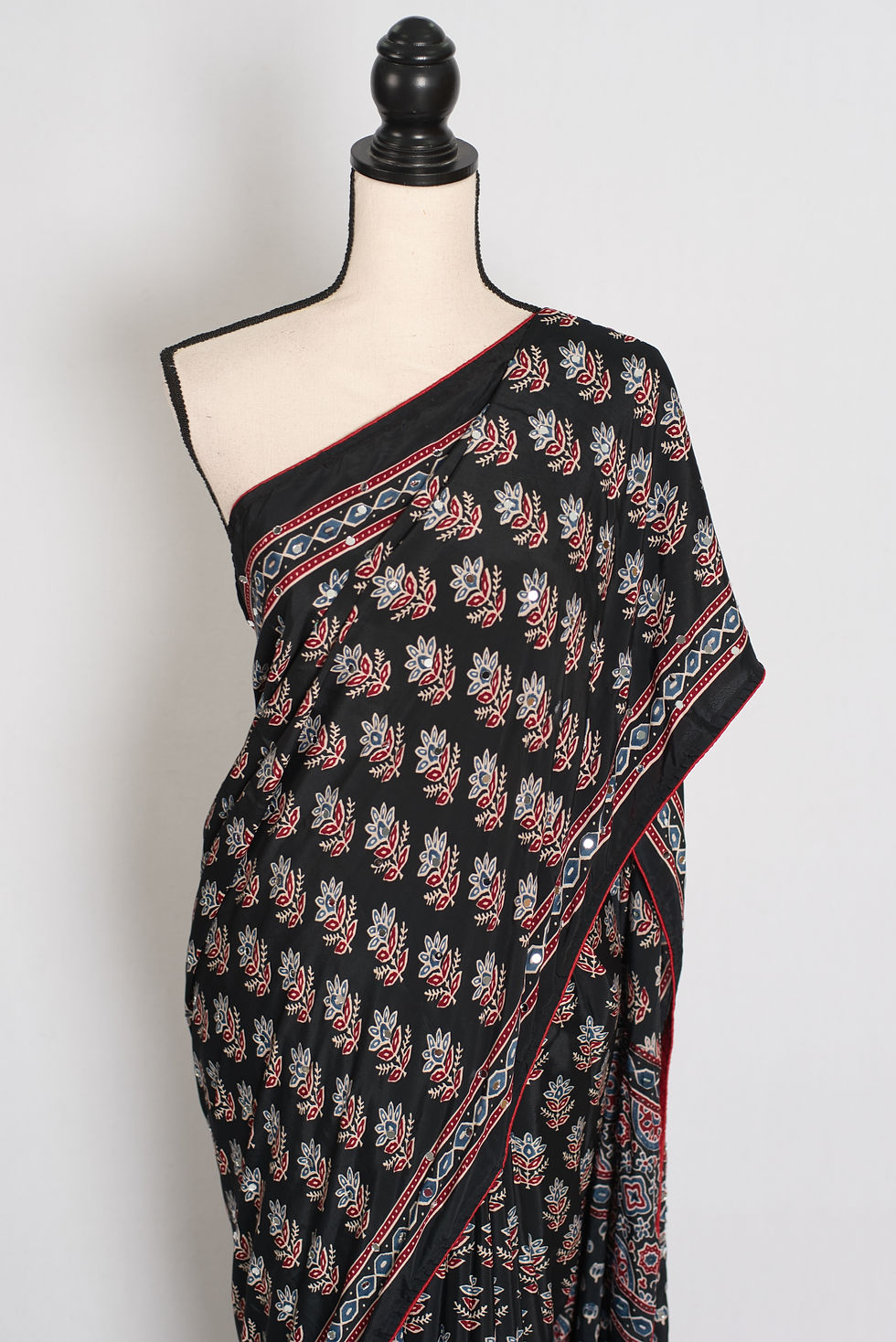 Thumbnail: Black semi modal silk partywear saree draped on a mannequin, showcasing mirror work.