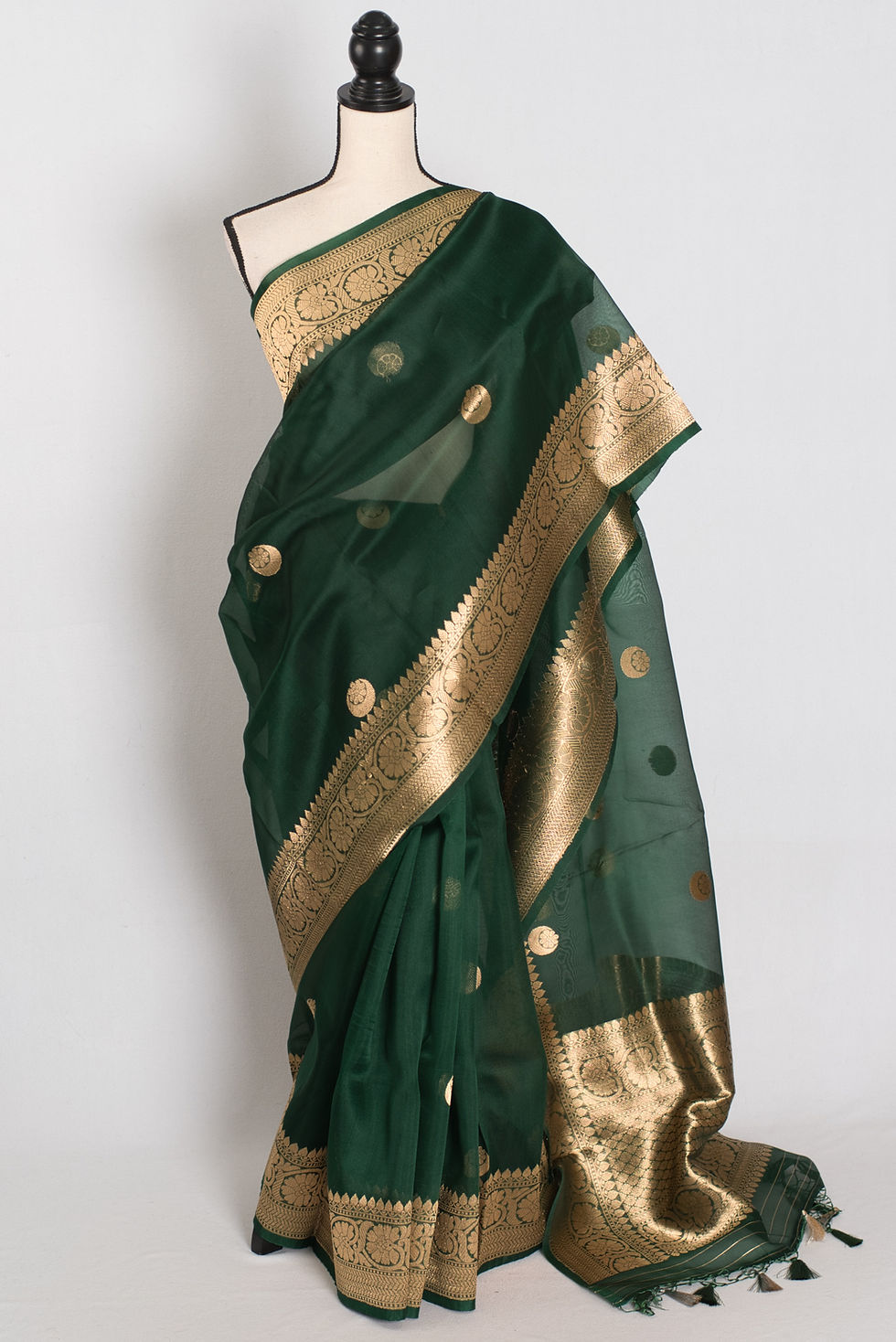 bottle green and gold kora organza banarasi saree featuring hand woven chand sitara motifs on a mannequin drape.