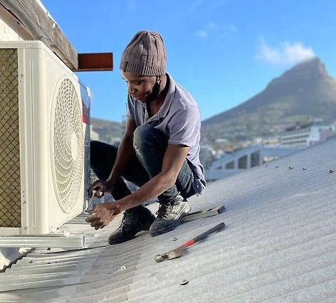 Technician servicing wall aircon in Cape Town