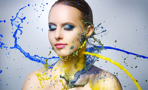 Beautiful girl and colorful paint splashes on light background.jpg