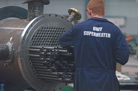 A workman putting tubes into a superheater