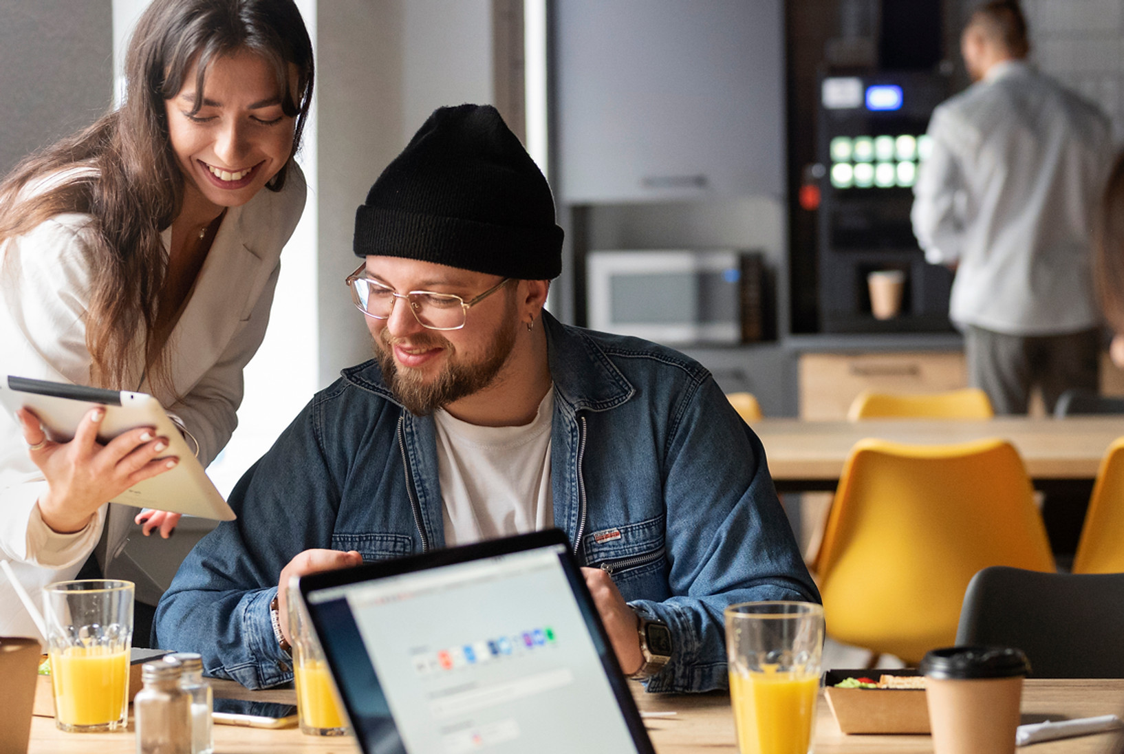 Group of professionals using tablets and laptops — symbolizing digital tools for guest communication and hotel feedback