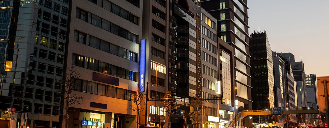 City hotel on a main street at night — representing modern technology and connectivity solutions for urban hospitality venues