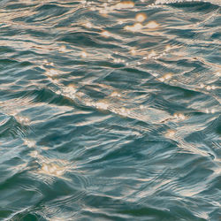 Golden Hour painting of sunlight sparkling on water by Elizabeth Geisler