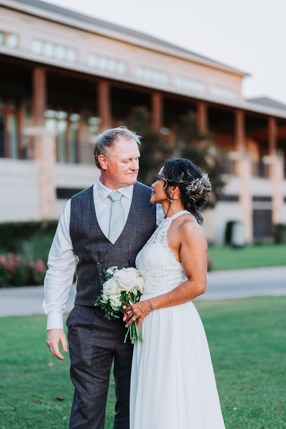 Wedding portrait of a couple looking at each other during sunset at the Woodlands Country Club in Woodlands, Texas.
