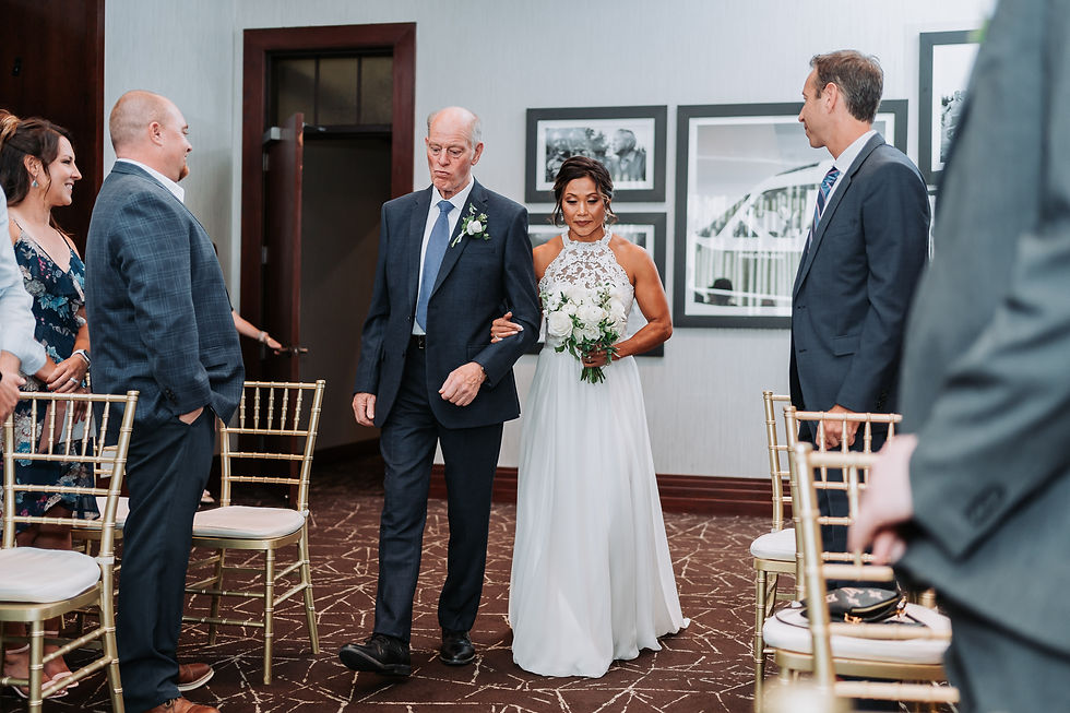 Bride walking down the aisle at the Woodlands Country Club in Woodlands, Texas.