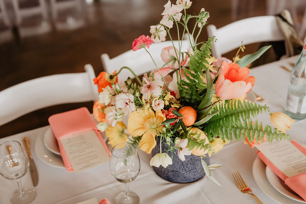 Bright, spring centerpiece for a long guest table at a wedding.