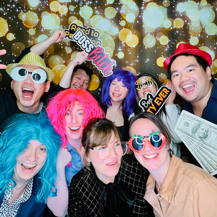 CEO and executives posing in a corporate photo booth rental for a gala.