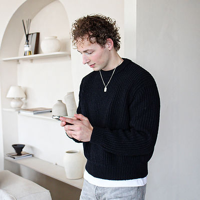 Social media manager al staand aan het werk op zijn telefoon.