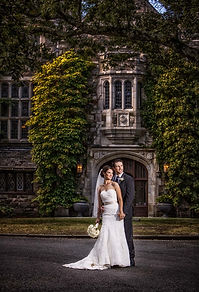 Bride and groom pose outside historic building