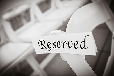 Reserved sign on white chairs