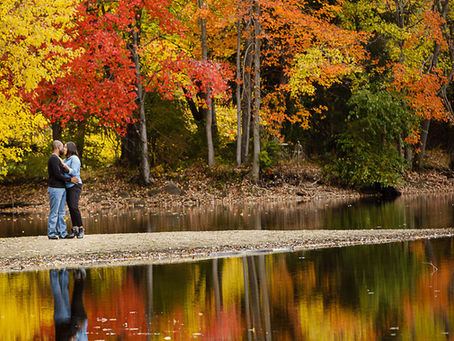 Couple on a pond with the autumn colors