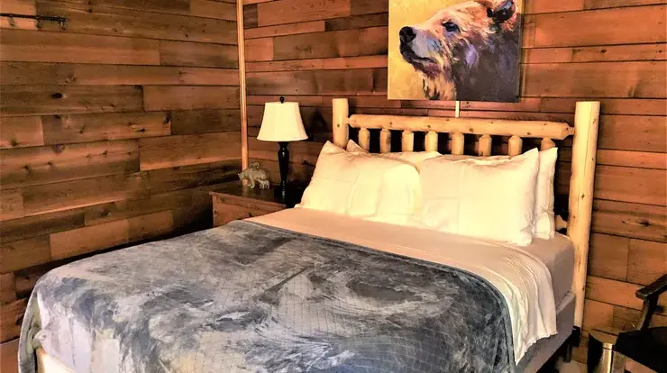 Bear Cave bedroom #1. This bedroom has a queen sized bed, end tables, and a full sized dresser.