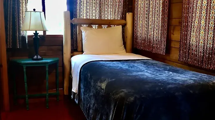 One of two Twin XL beds in Bear Cave's bedroom #3. Bedroom is configured as a tandem room. There is a door separating the two twin beds.