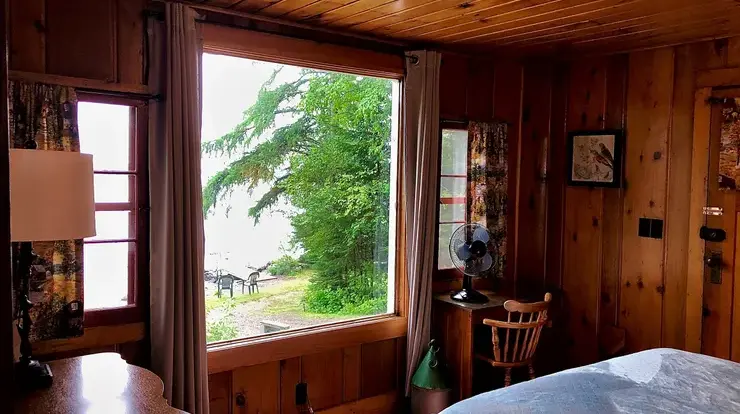 There is a large picture window in this room overlooking the lake and dock area.
