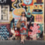 woman stood against colourful wall | family photographer Durham | Angela Fenwick Photography