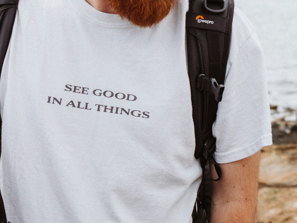 A man had a plain white shirt with black texts that reads "see good in all things". This is an example of a creative affirmation.