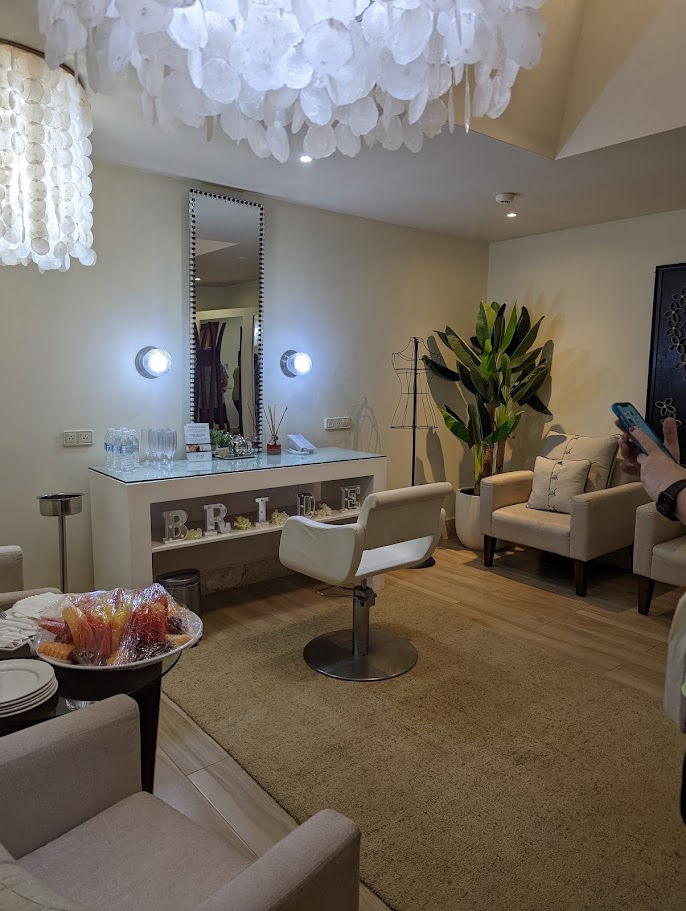 Elegant resort bridal suite with vanity, salon chair and comfortable seating