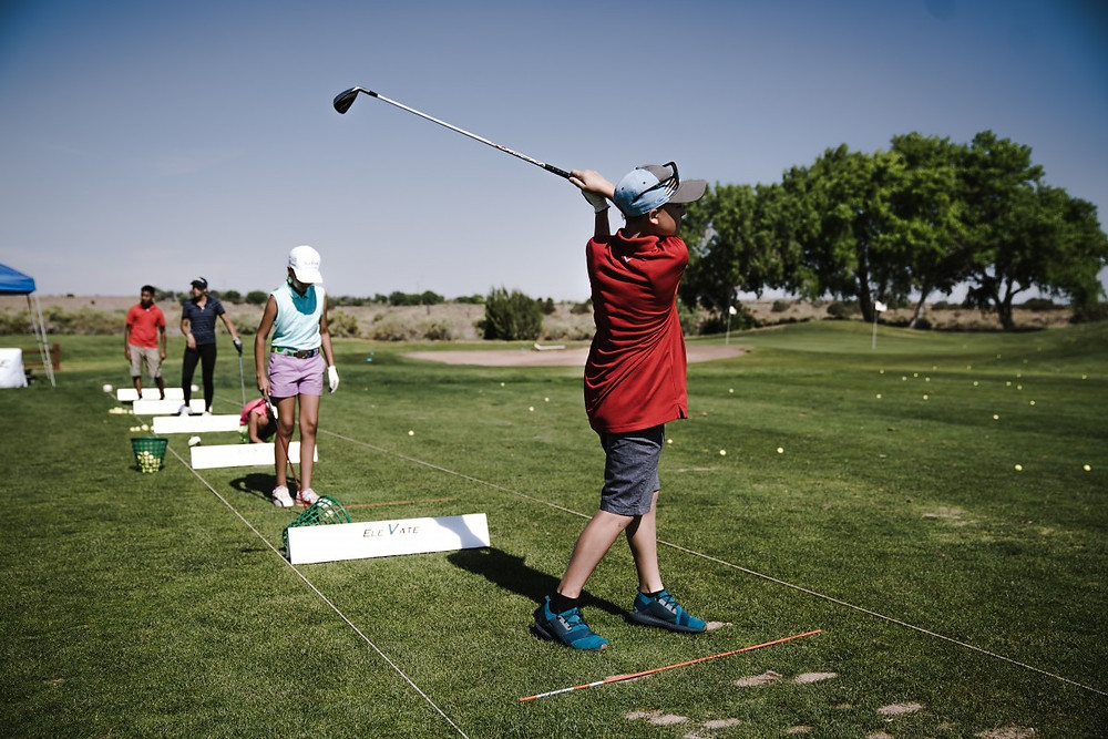 children playing golf at a golf course
