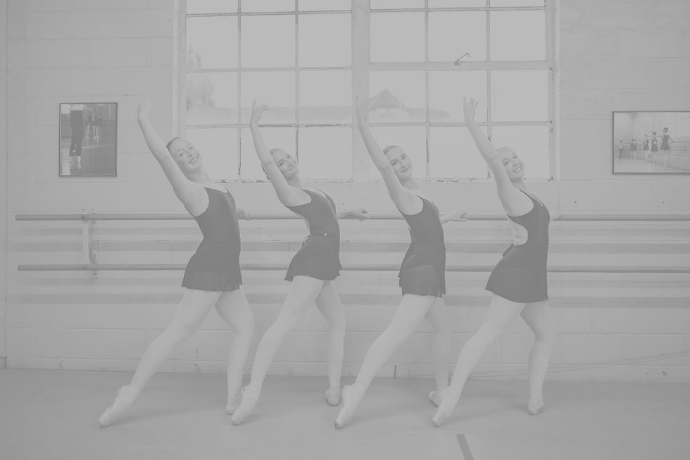 Four dancers at barre