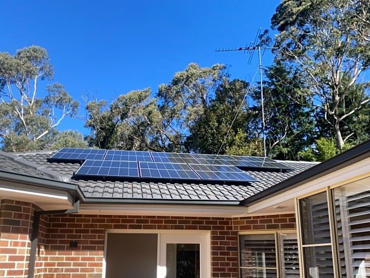 Solar panels on a tiled roof of a brick home in Leura, Blue Mountains