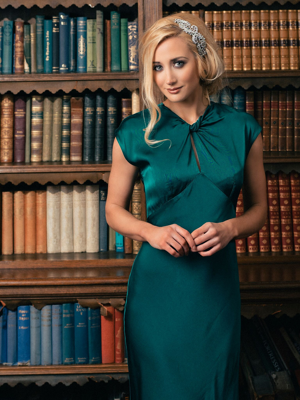 Bridesmaid in the colstoun library, weather a green dress with crystal headpiece