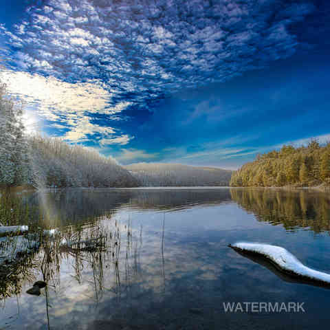 Green Lakes - Winter view of a lake with trees on either side.