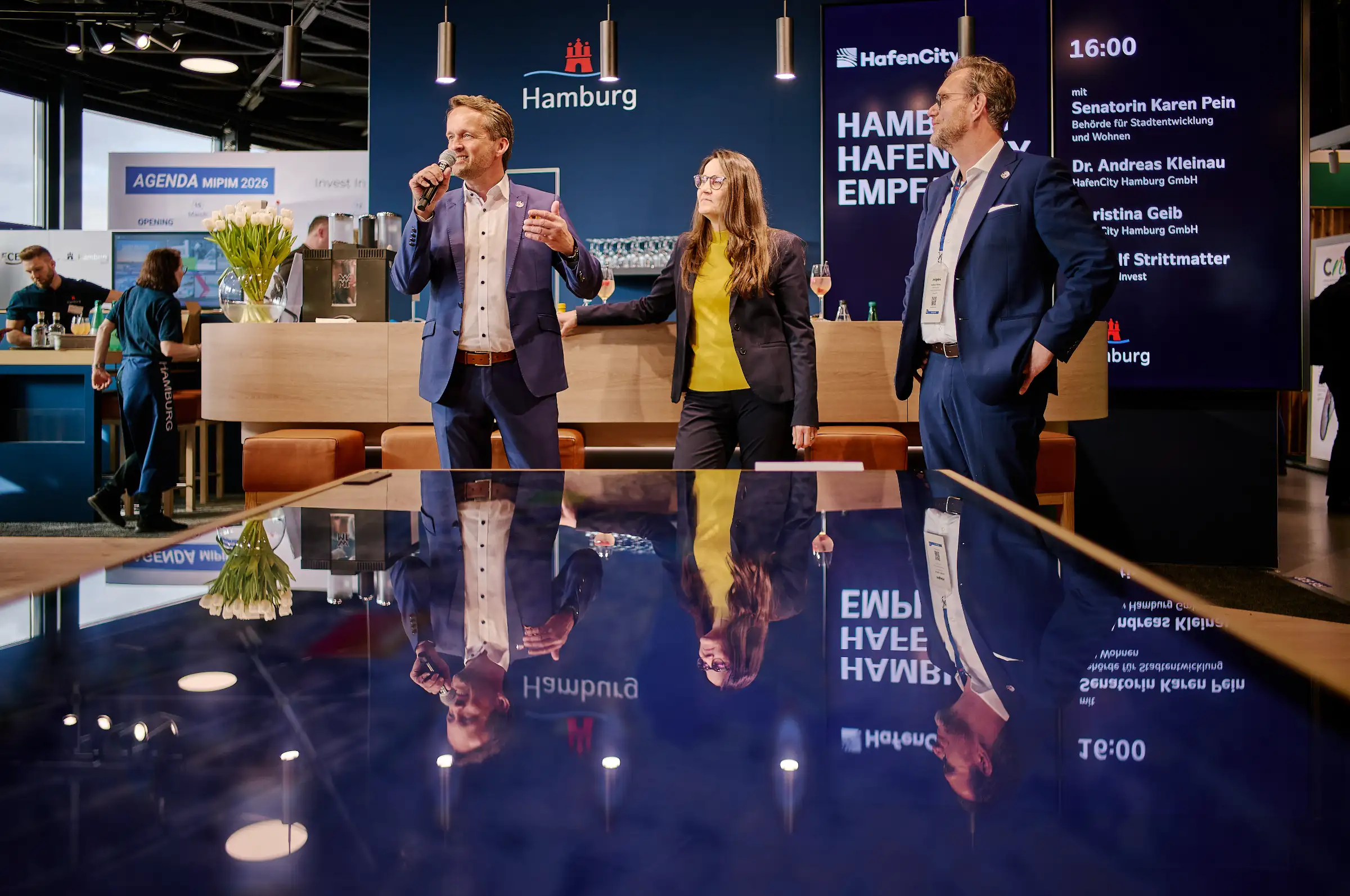 Dr. Andreas Kleinau, Karen Pein, and Dr. Rolf Strittmatter present at the Hamburg stand during MIPIM