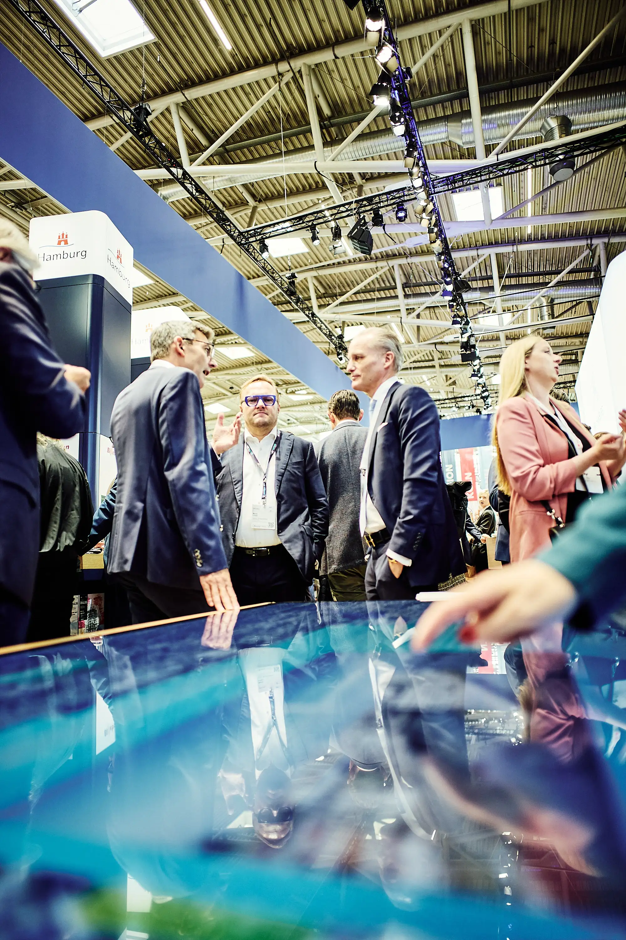 People at EXPO REAL 2025 viewing motion graphics display