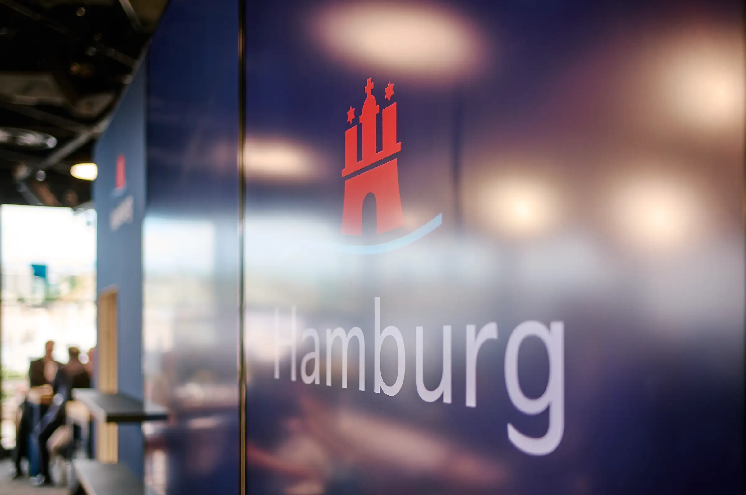 Official Hamburg branding and logo on a display panel at the Hamburg stand during MIPIM 2024.