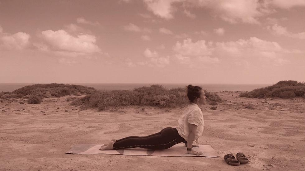 joni fleischer doing yoga outside at the bunda cliffs on a roadtrip across australia