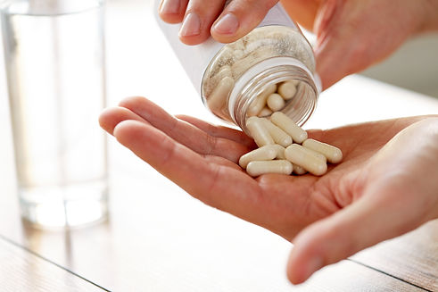 close-up-of-man-pouring-pills-from-jar-to-hand-2026-03-09-07-59-48-utc.jpg