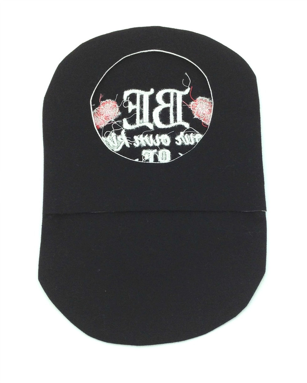 Black stoma bag cover embroidered with roses and the words be your own kind of beautiful.