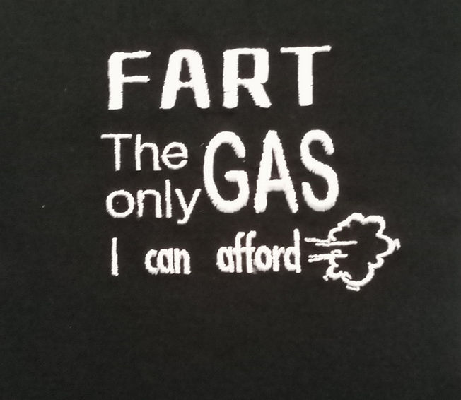 Fart the only gas I can afford embroidered in white onto a black fabric stoma bag cover.