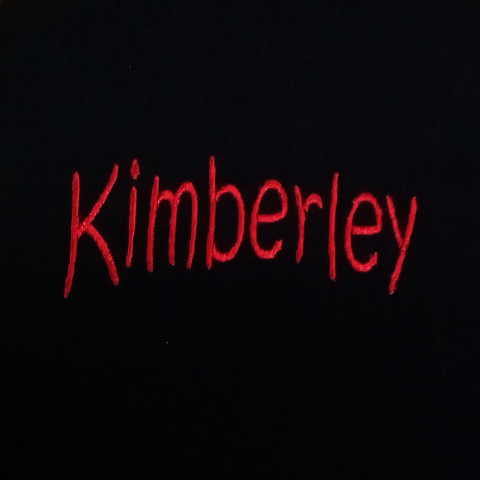 Black stoma bag cover embroidered with your choice of name.