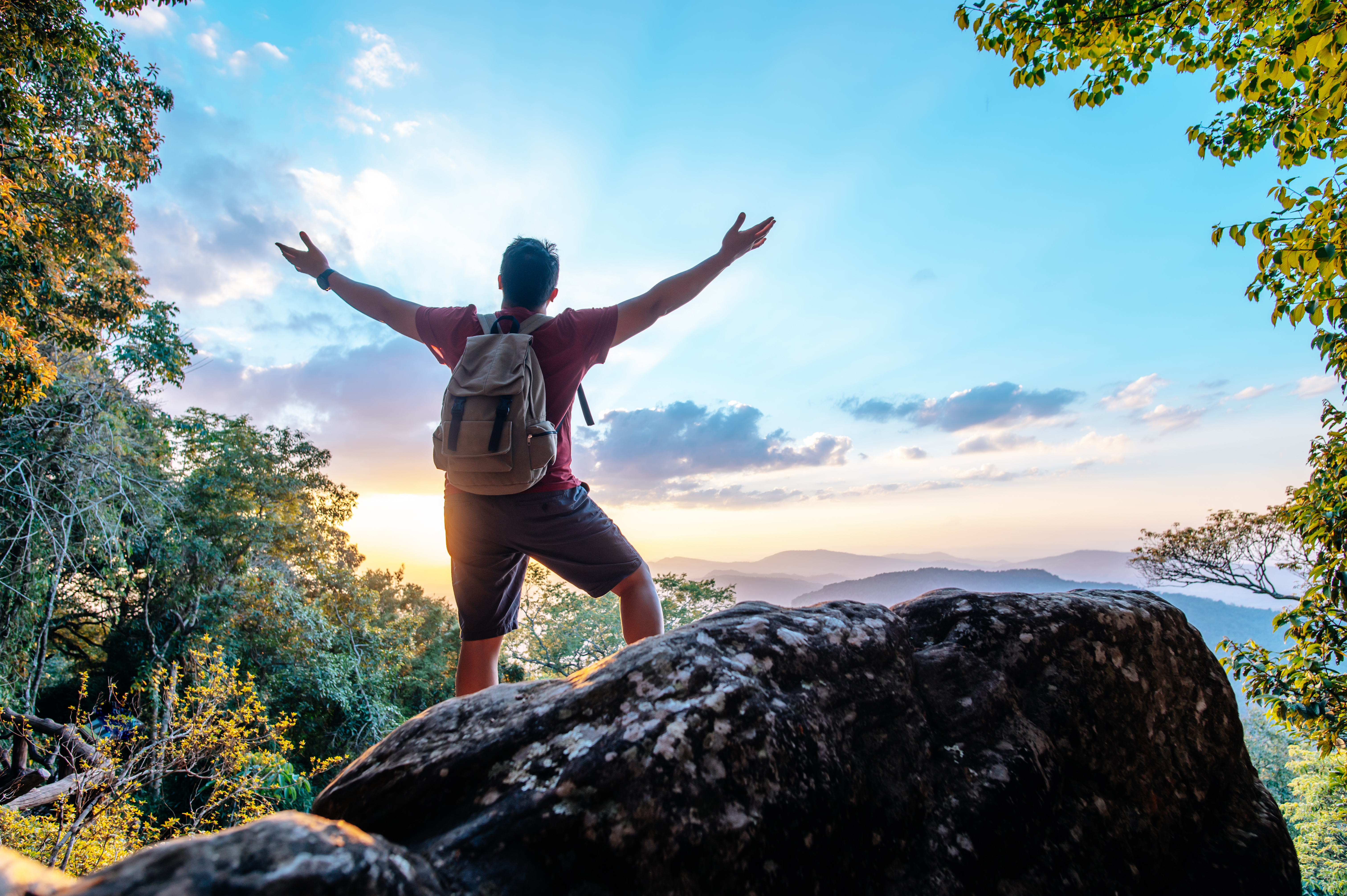 rear-view-back-young-asian-hiking-man-standing-riseup-hands-with-happy-peak-rocky-mountain