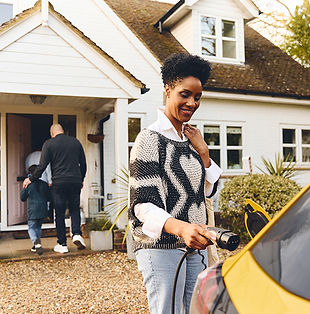 woman-plugging-in-electric-charger-into-car-with-f-2024-11-27-05-43-53-utc.jpg