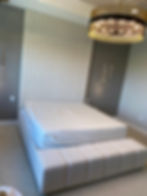 Modern custom upholstery bed with fluted headboard and bench.