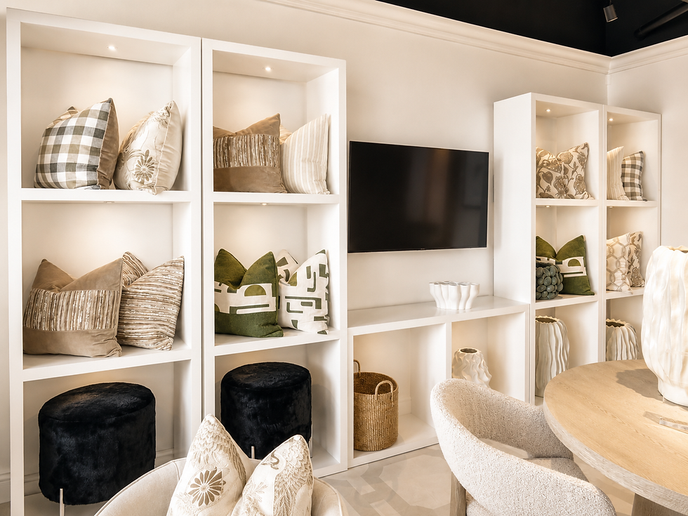 Curated furniture and decor on white built-in shelving.