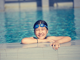 Happy girl swimming in pool