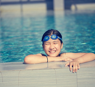 Happy girl swimming in pool