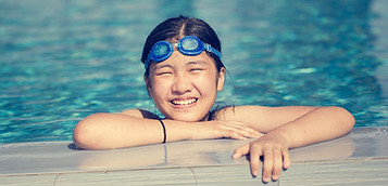 Happy girl swimming in pool