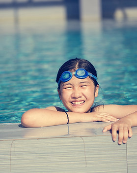 Happy girl swimming in pool