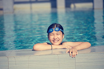 Happy girl swimming in pool