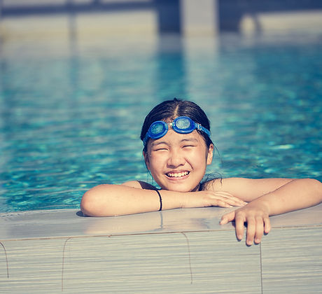 Happy girl swimming in pool