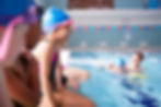 male-coach-in-water-giving-group-of-children-swimm-2022-02-08-22-39-29-utc.jpg