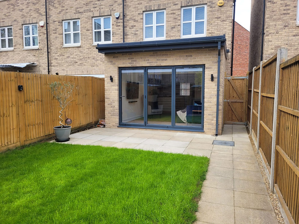 Front shot of what can be considered a garden room extension finished with london stock brick slips and a 3m bifold door 